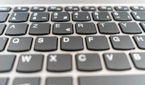 Close-up of a computer keyboard with dark and flat keys Stock Photos