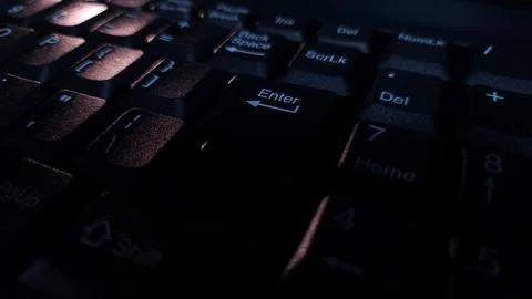 Close-up of computer keyboard in dark background. Stock Photos