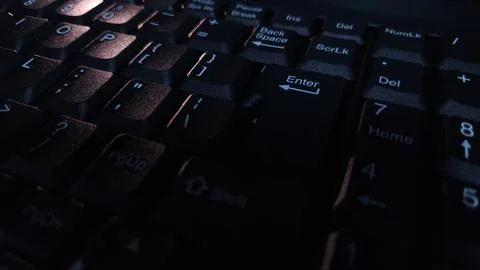 Close-up of computer keyboard in dark background. Stock Photos