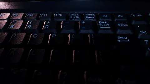 Close-up of computer keyboard in dark background. Stock Photos
