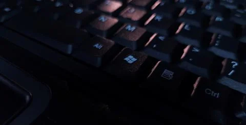 Close-up of computer keyboard in dark background. Stock Photos