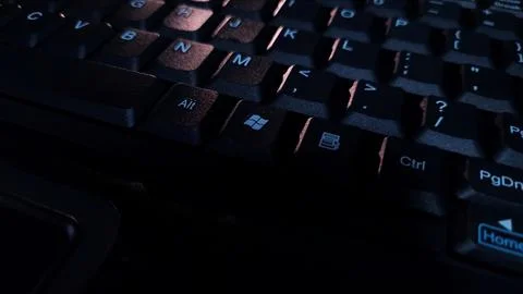 Close-up of computer keyboard in dark background. Stock Photos