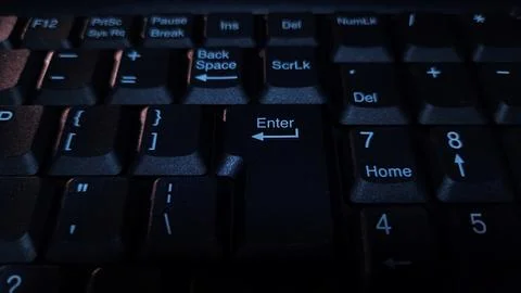 Close-up of computer keyboard in dark background. Stock Photos