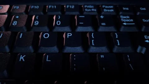 Close-up of computer keyboard in dark background. Stock Photos