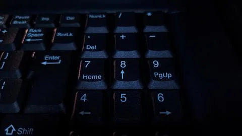 Close-up of computer keyboard in dark background. Stock Photos