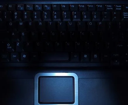 Close-up of computer keyboard in dark background. Stock Photos
