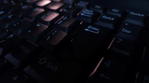 Close-up of computer keyboard in dark background. Stock Photos