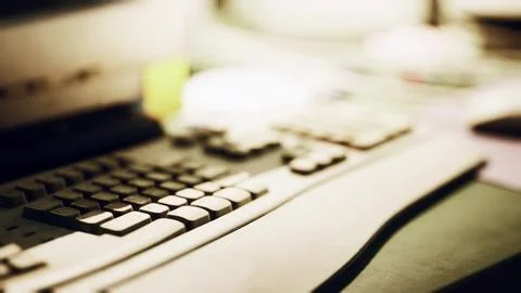 Close up of a computer keyboard on a desk with soft ambient lighting 스톡 일러스트