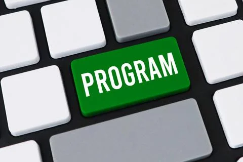 Close-up of a computer keyboard with a green key and white text that reads .. Stock-Fotos