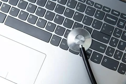 Close-up of a computer keyboard with a magnifying glass Stock Photos