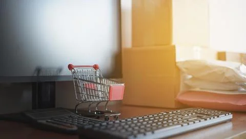 Close up of computer keyboard with small shopping cart Stock Photos