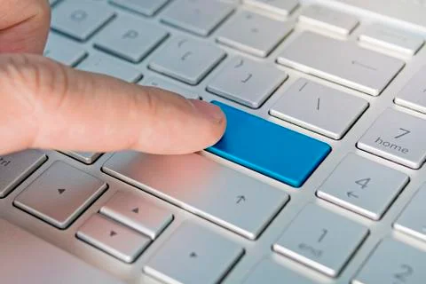 Close up of computer laptop keyboard with a blank blue button for any message Foto stock
