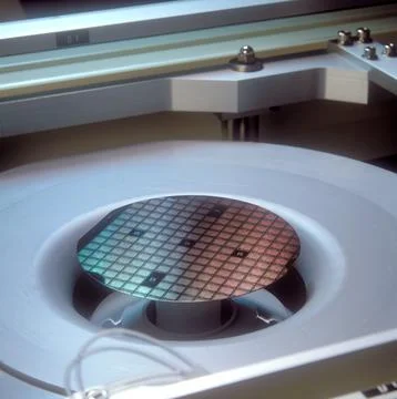 A close up of a computer microchip wafer being manufactured Stock Photos