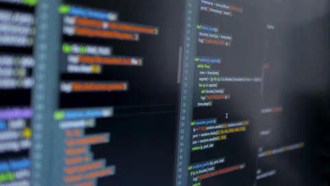 Close up computer monitors displaying fictional programming code 스톡 동영상 331410748