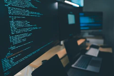 Close up of computer monitors displaying source code in a modern workstatio.. Foto stock