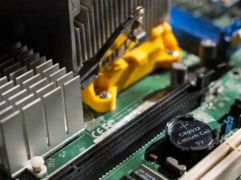 Close-Up of Computer Motherboard Components and Battery Stock Photos