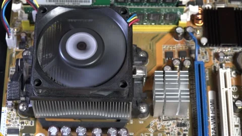 Close-Up of Computer Motherboard Featuring Cooling Fan and Circuitry - C0060 Stock Footage 293855994