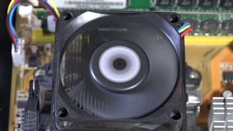 Close-Up of Computer Motherboard Featuring Cooling Fan and Circuitry - C0061 Stock Footage 293856456