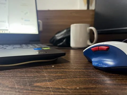 Close Up Of Computer Mouse On Wooden Office Desk Stock Photos