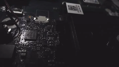 A close up of a computer part with a yellow light on it. The image is in blac Stock Footage 344909510