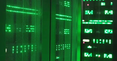 Close up of computer processor with green lights working in dark server space Stock Footage 137551490