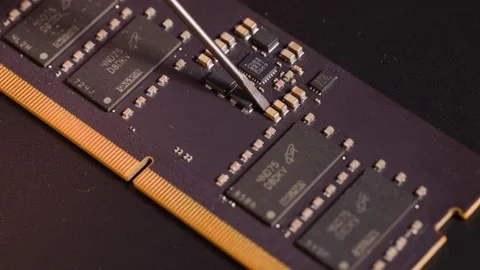 Close up of computer RAM module with skilled hand inspecting tiny component.. Stock Footage 334365465
