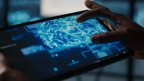 Close up of computer scientist in data center uses AI on tablet Stock Photos