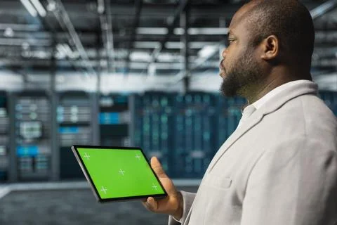 Close up of computer scientist in data center using green screen tablet Stock Photos