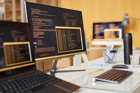 Close Up Computer Screen with Code Lines on Desk in IT Development Office 写真素材