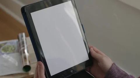 Close up of computer screen as hand swipes and holds Stock Footage 70809619