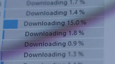 Close-up of computer screen showing multiple files downloading with blue Stock Footage 318012895