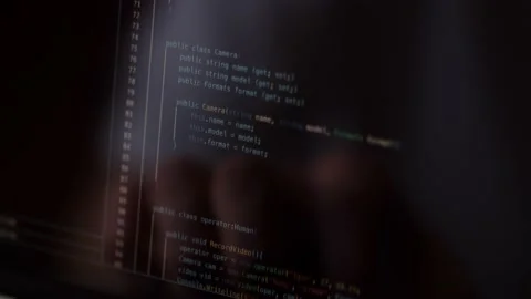 A close-up of a computer screen on which program code is scrolling. A web Stock Footage 236643721
