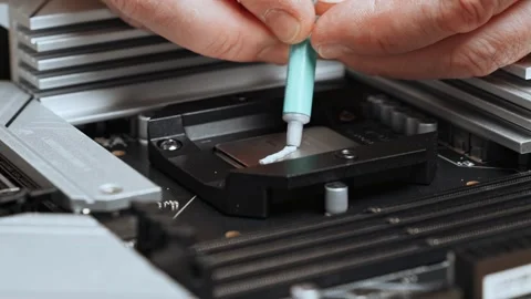 Close-up of a computer technician applying thermal paste to a processor Stock Footage 300197247