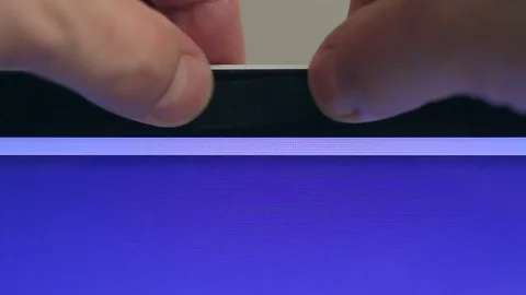 Close-up of a computer user glues the web camera of a laptop with black tape Stock Footage 81853210