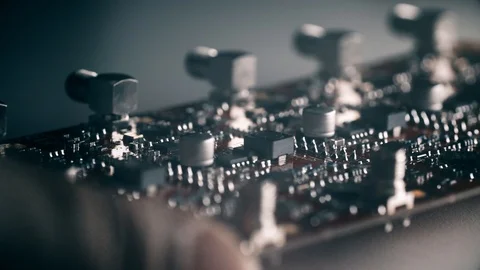 A close up of computerized circuit board while being checked under a microscope. Video stock 87181446