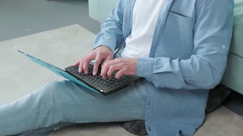 Close up of a concentrated beaded man, thinking and typing, with his laptop. Stock Footage 156338888
