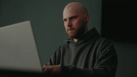 Close-up of concentrated bearded male programmer diligently typing on laptop Stock Footage 305498633