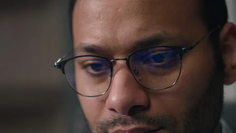 Close up concentrated entrepreneur work online with computer data male eyes in Stock Footage 249544396