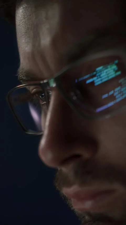 Close up of concentrated programmer in glasses works late at night Stock Footage 317987896