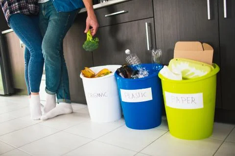 Close-up concept. Sort garbage at home. There are three buckets for different Stock Photos