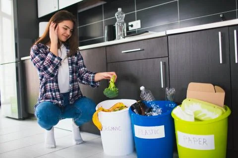 Close-up concept. Sort garbage at home. There are three buckets for different Stock Photos