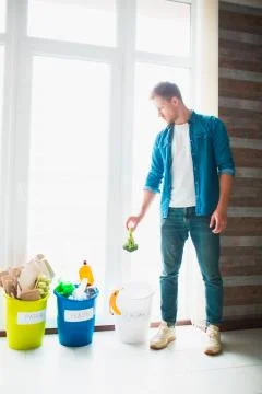 Close-up concept. Sort garbage at home. There are three buckets for different Stock Photos