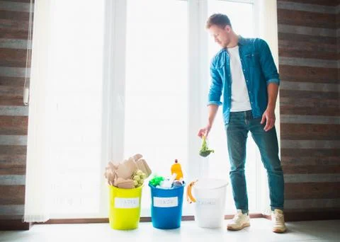 Close-up concept. Sort garbage at home. There are three buckets for different Stock Photos