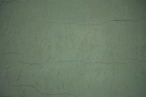 Close-up of a concrete background with cracks. Light green tint. Texture Stock Photos