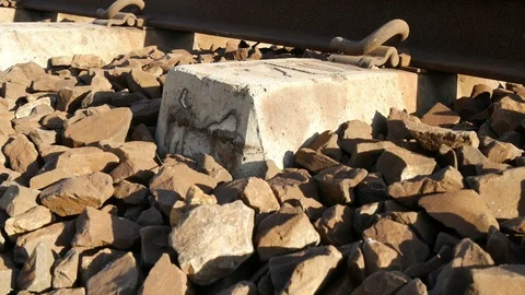 Close up concrete railway sleeper crane to rail tracks perspective 動画素材 100620928
