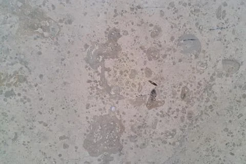 Close-up of a concrete surface displaying a weathered texture with various st Stock Photos