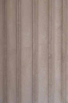 Close-up of a concrete wall with vertical lines and texture Stock Photos