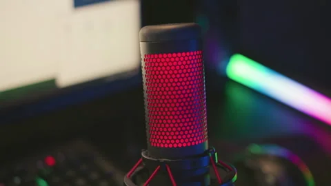 Close up condenser mic with red light and blurred computer setup Stock Footage 307460143