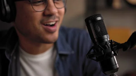 Close-up condenser microphone of content creator man host streaming his. Stock Footage 186481984