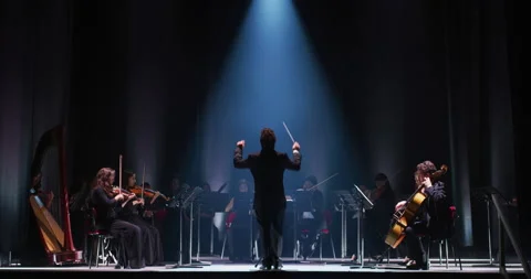 Close up of conductor directing symphony orchestra on classic theatre stage Stock Footage 154006797